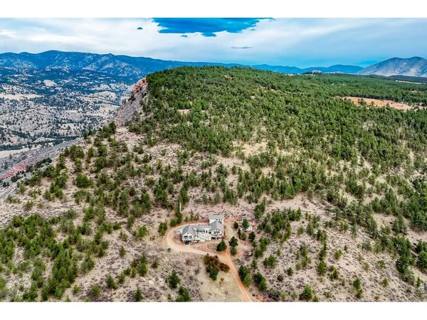 an aerial view of a house with a yard