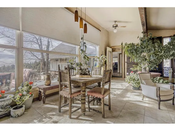 a view of a dining room with furniture and a potted plant