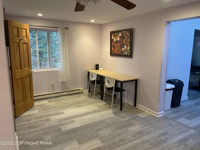 a view of work space with furniture and windows