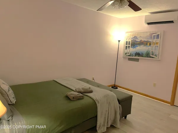 a bed sitting in a bedroom next to a window