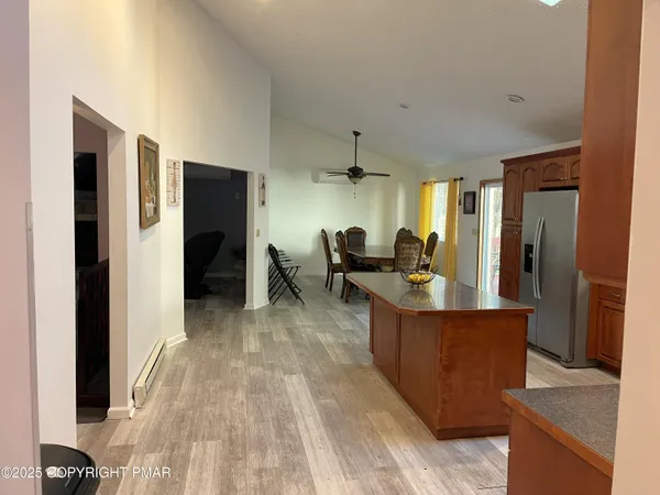 a view of kitchen with refrigerator stove and wooden floor
