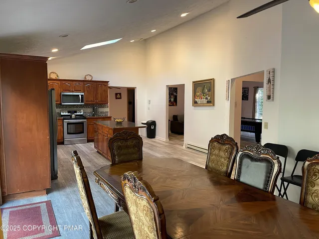 a living room with furniture a piano and a flat screen tv
