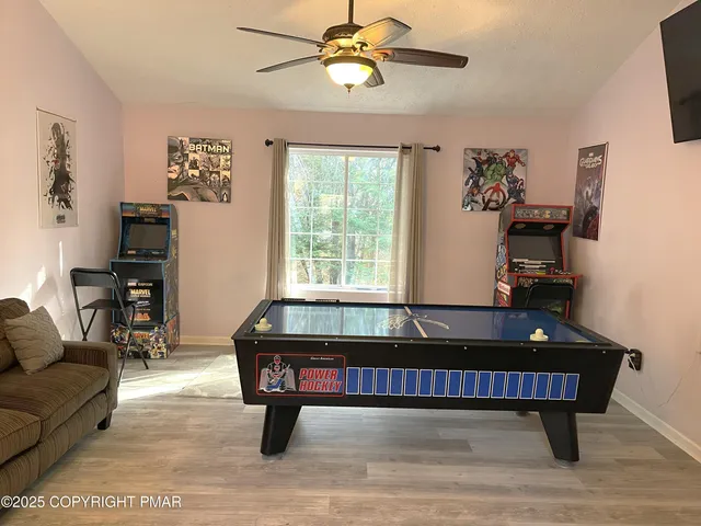 a living room with furniture a piano and a window