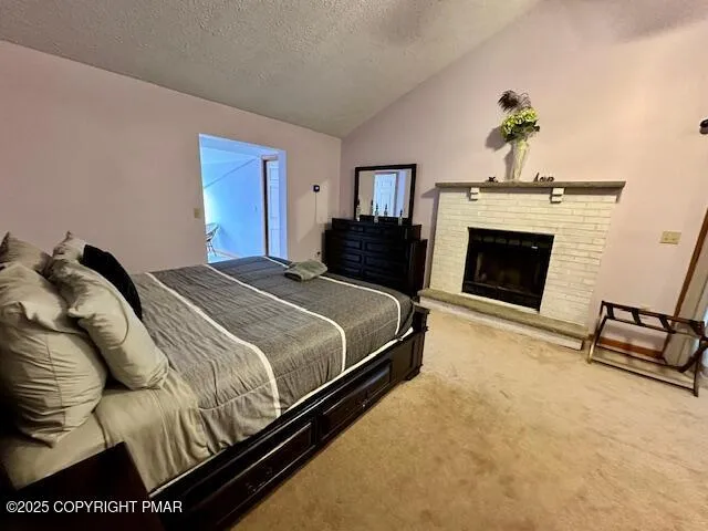 a bedroom with a bed and a fireplace
