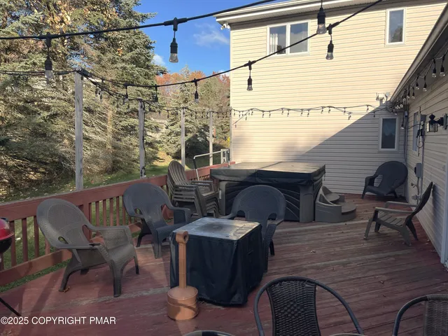 a balcony with table and chairs