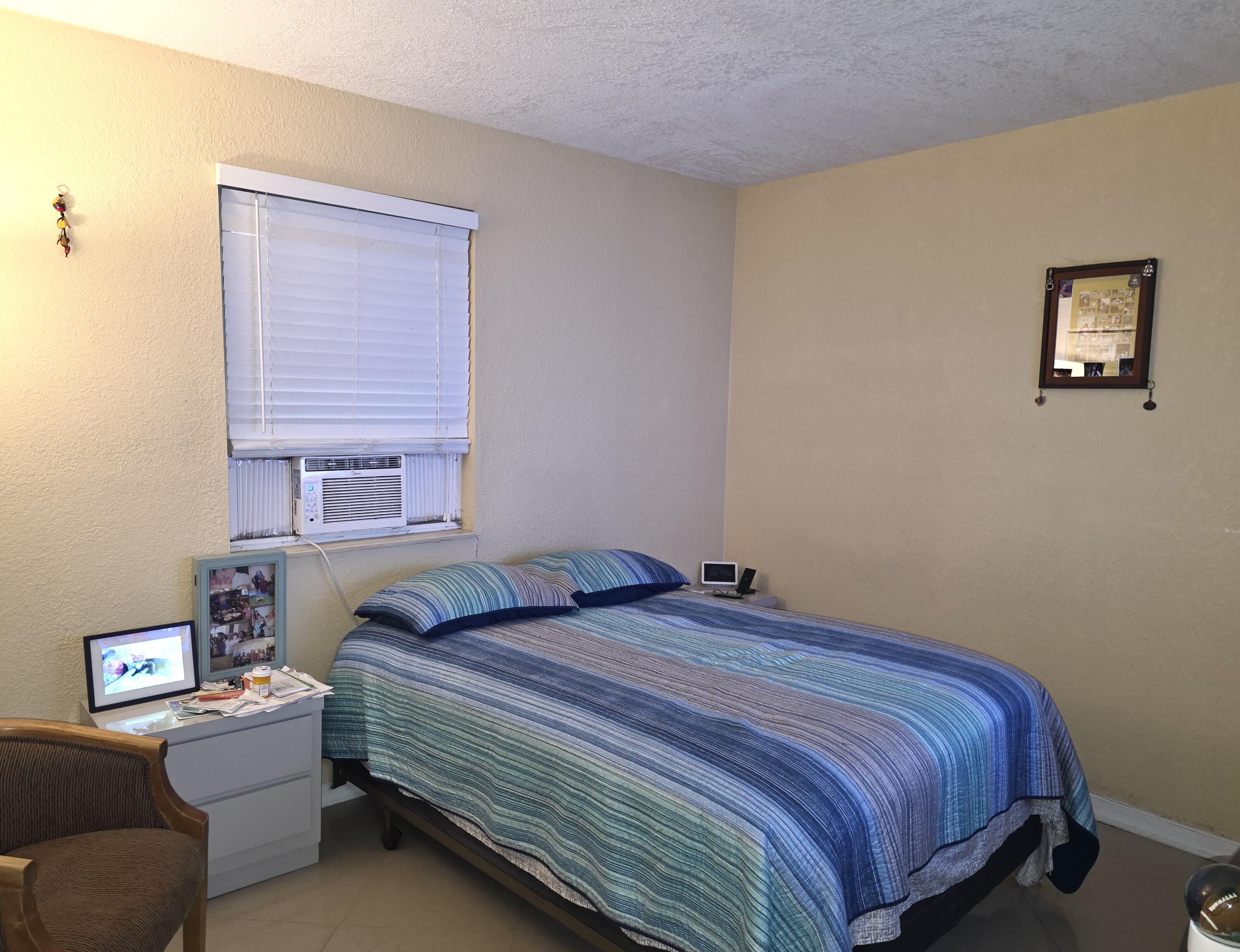 4118 Ruth Road Lake Worth, FL 33461 - Photo 13 of 21 a bedroom with a bed and a window