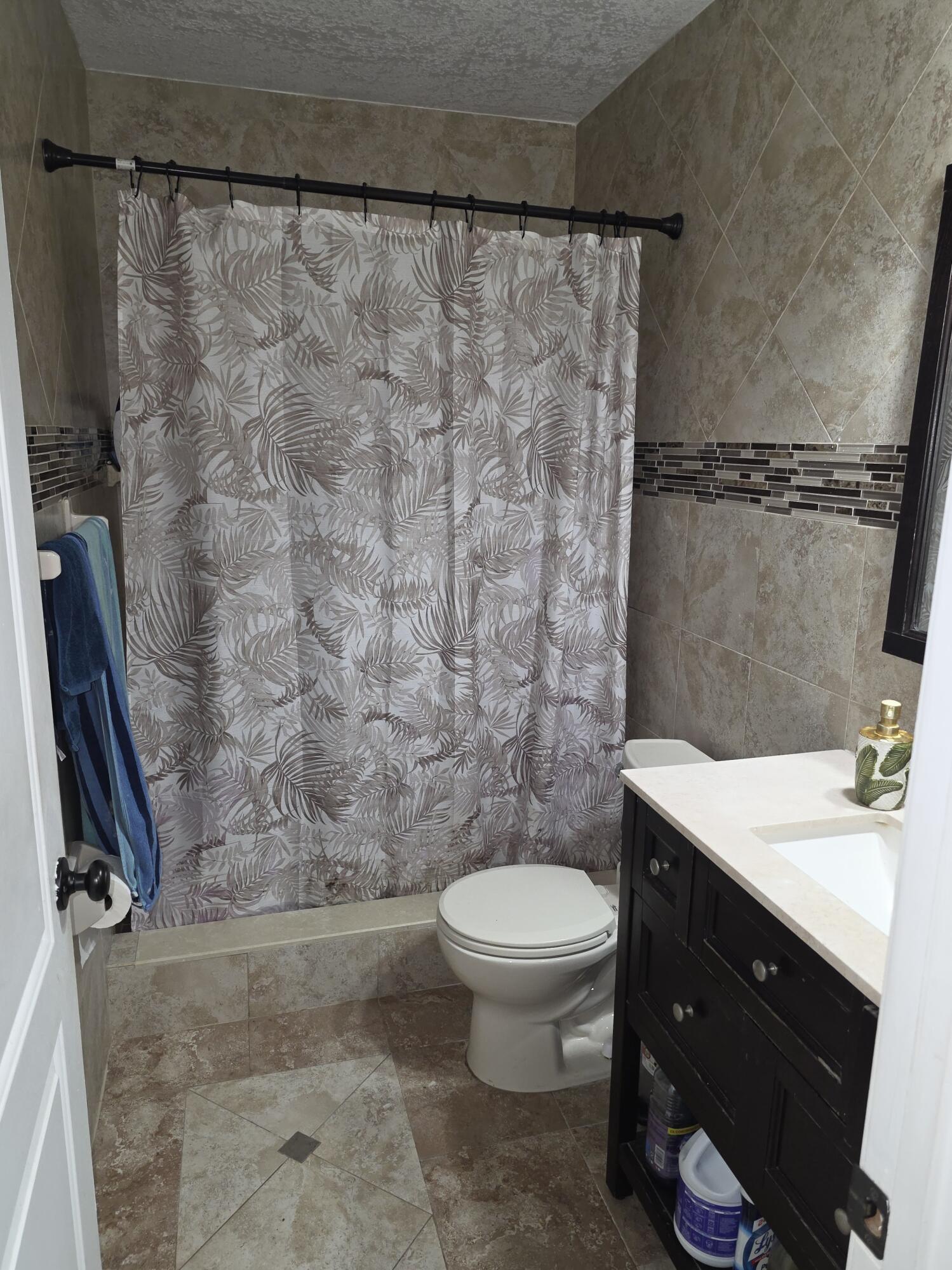 4118 Ruth Road Lake Worth, FL 33461 - Photo 14 of 21 a bathroom with a sink a toilet and shower