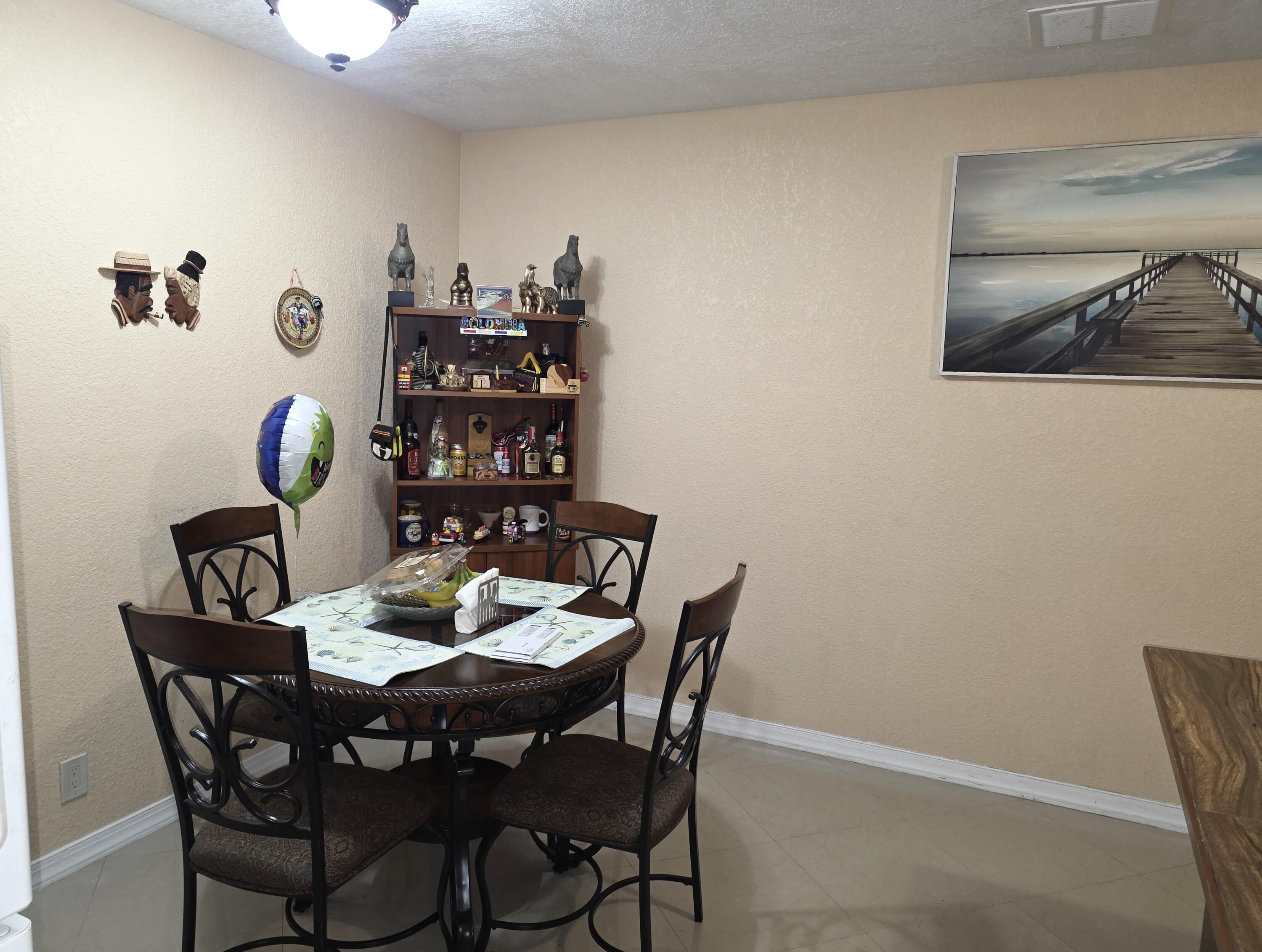 4118 Ruth Road Lake Worth, FL 33461 - Photo 16 of 21 a view of a dining room with furniture and wooden floor