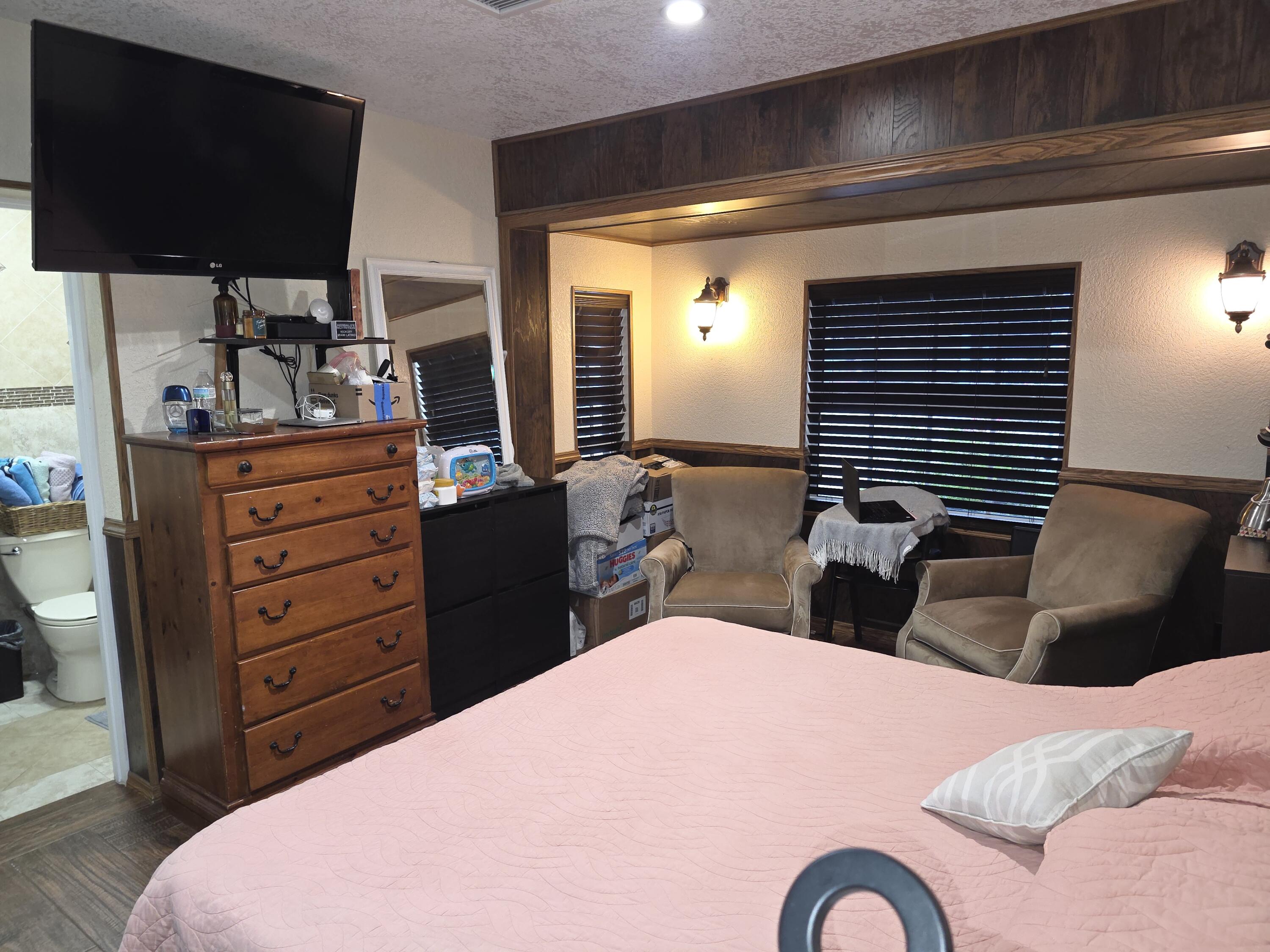 4118 Ruth Road Lake Worth, FL 33461 - Photo 20 of 21 a bedroom with a bed and a flat screen tv