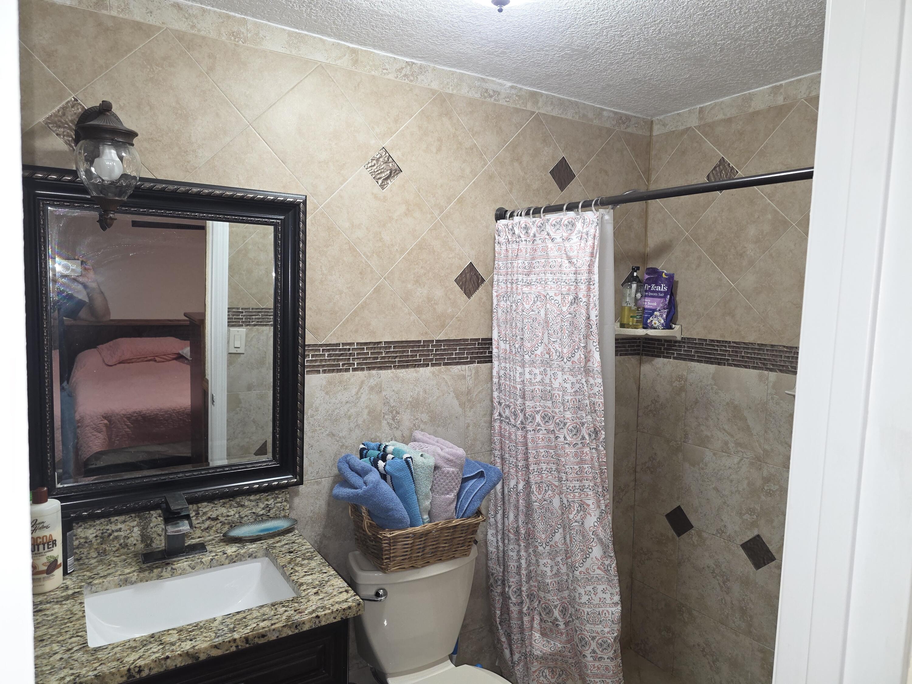 4118 Ruth Road Lake Worth, FL 33461 - Photo 21 of 21 a bathroom with a granite countertop sink toilet and shower