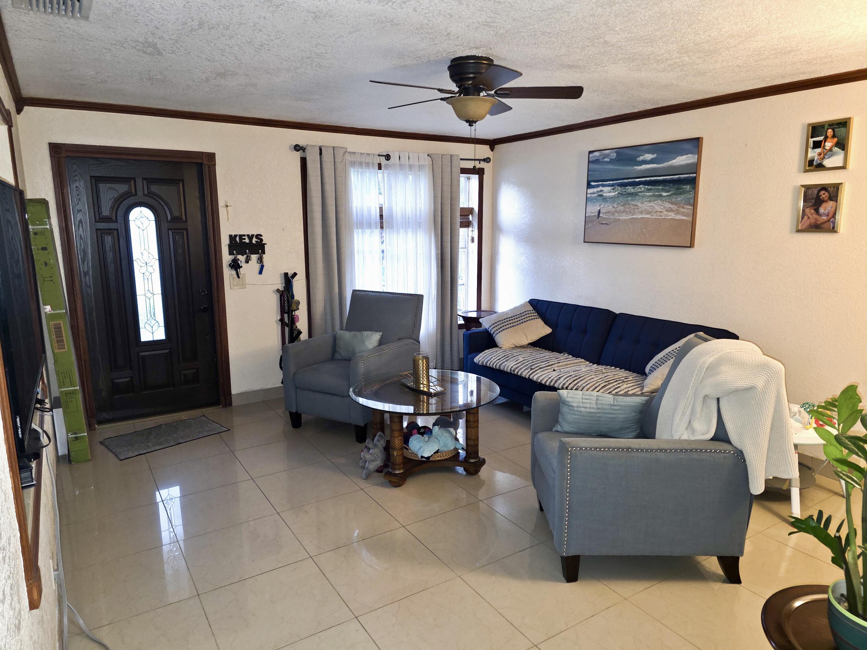4118 Ruth Road Lake Worth, FL 33461 - Photo 3 of 21 a living room with furniture and a large window