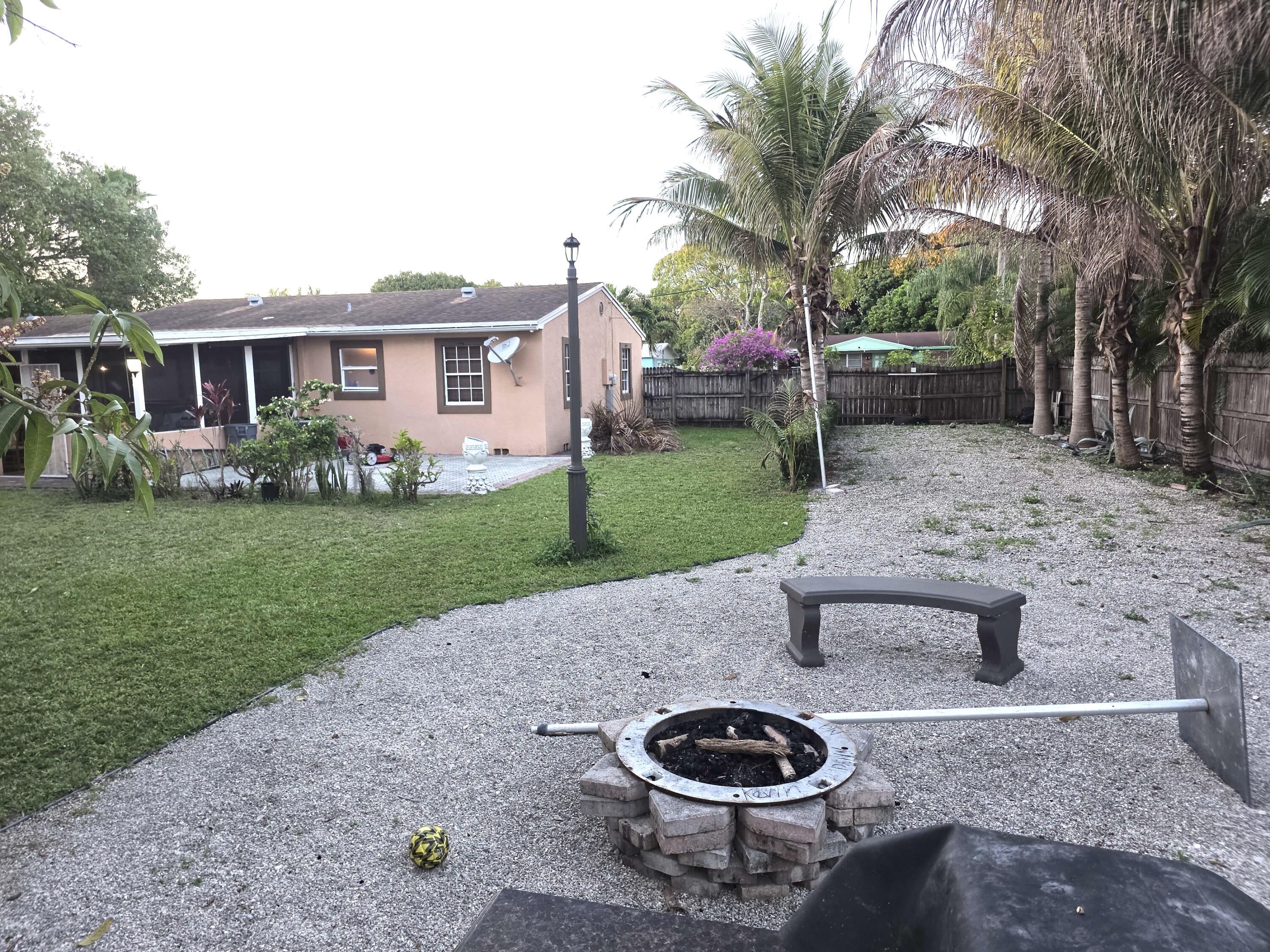 4118 Ruth Road Lake Worth, FL 33461 - Photo 6 of 21 a backyard of a house with barbeque oven and outdoor seating