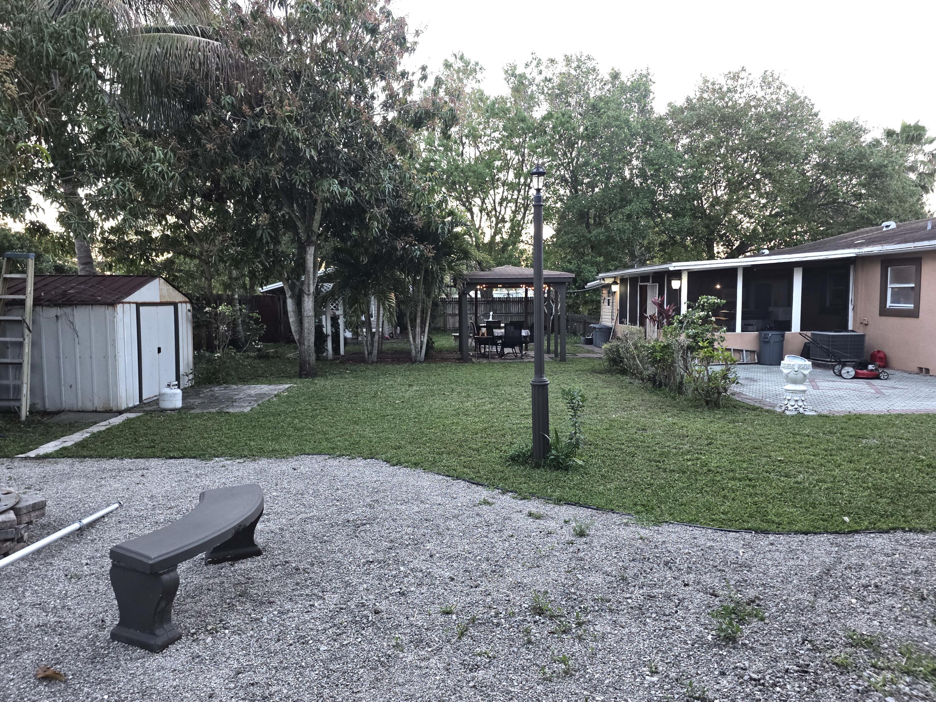 4118 Ruth Road Lake Worth, FL 33461 - Photo 7 of 21 a view of a backyard with plants and trees