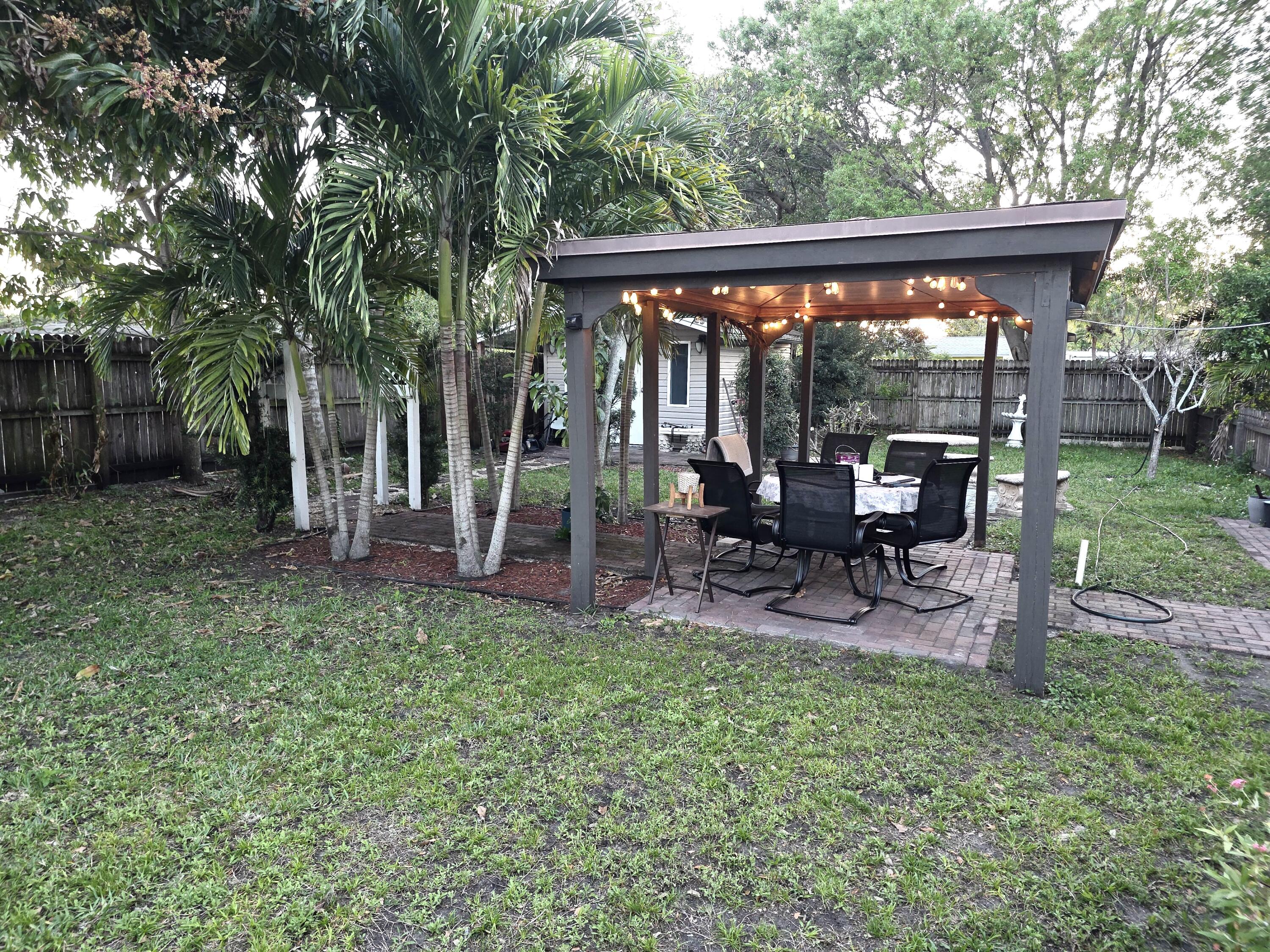 4118 Ruth Road Lake Worth, FL 33461 - Photo 9 of 21 a view of a chair and table in backyard of the house