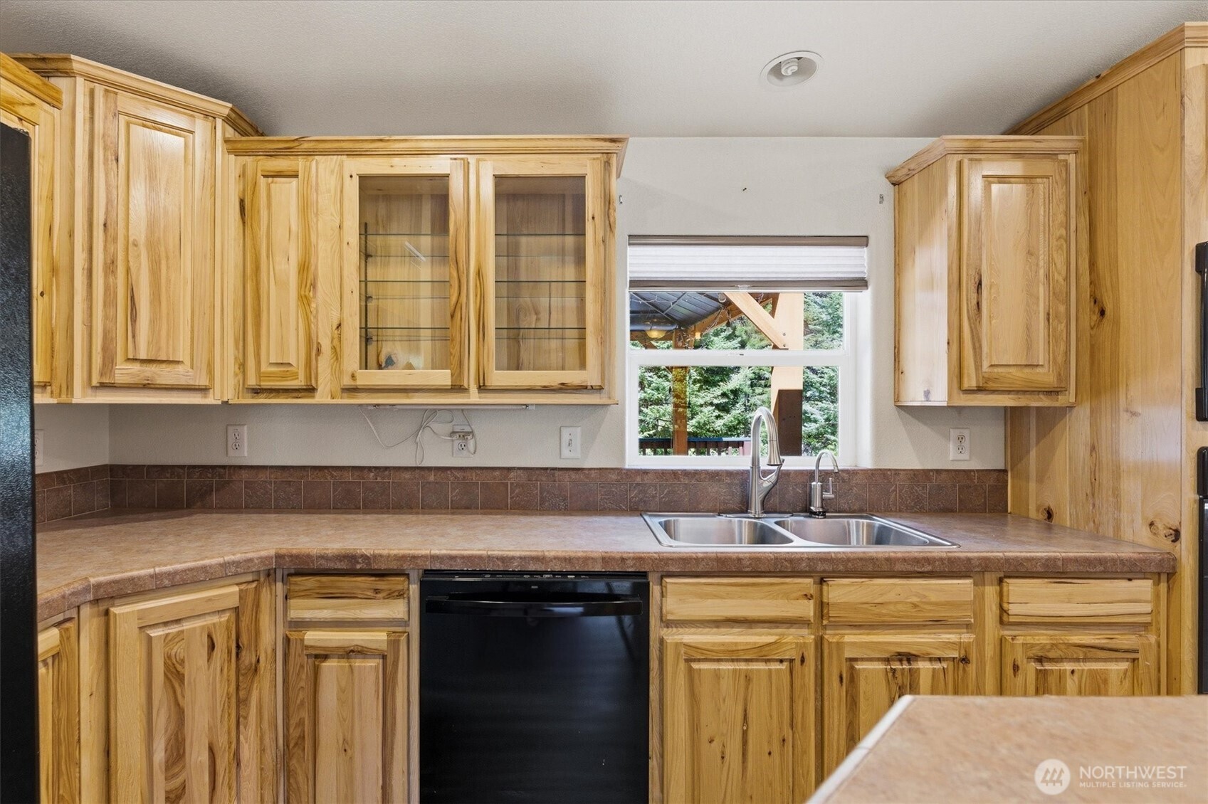 1142 Driskill Road Newport, WA 99156 - Photo 14 of 40 a kitchen with stainless steel appliances white cabinets and a window