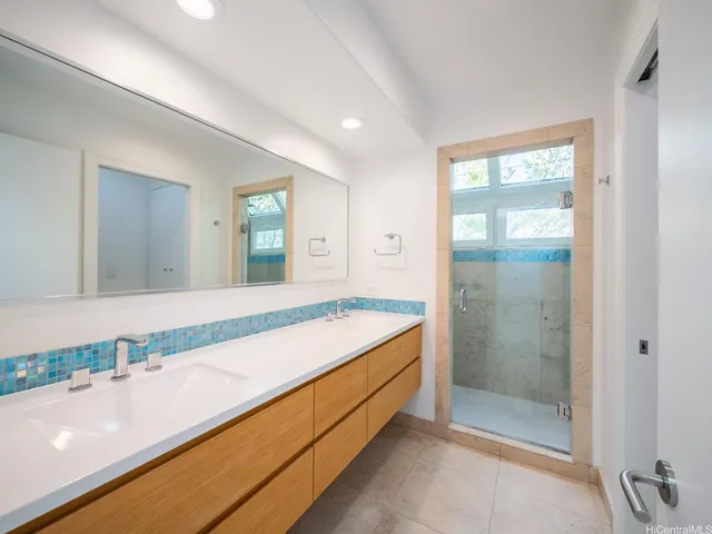 a spacious bathroom with a granite countertop sink and a mirror