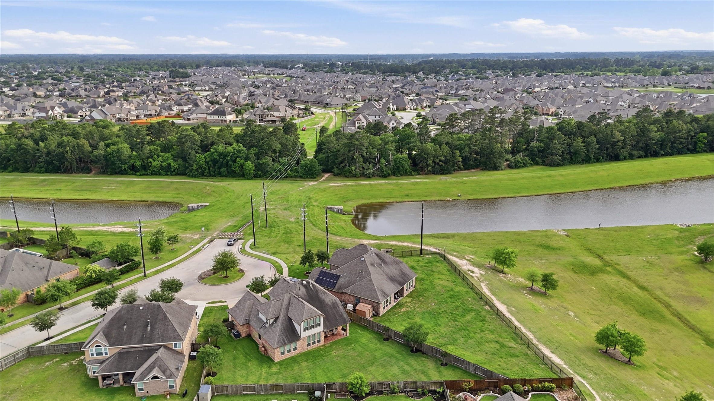 12506 Northpointe Ridge Lane Tomball, TX 77377 - Photo 29 of 31 an aerial view of a house with a garden and lake view