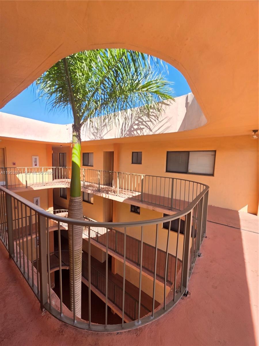 8600 Southwest 133rd Avenue Road, Unit 424 Miami, FL 33183 - Photo 16 of 27 a view of a balcony with a garden and wooden deck