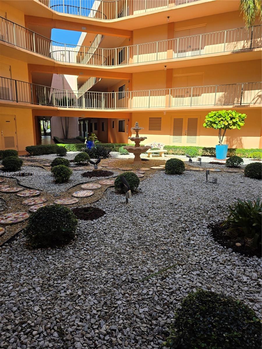 8600 Southwest 133rd Avenue Road, Unit 424 Miami, FL 33183 - Photo 20 of 27 a view of a building with a yard