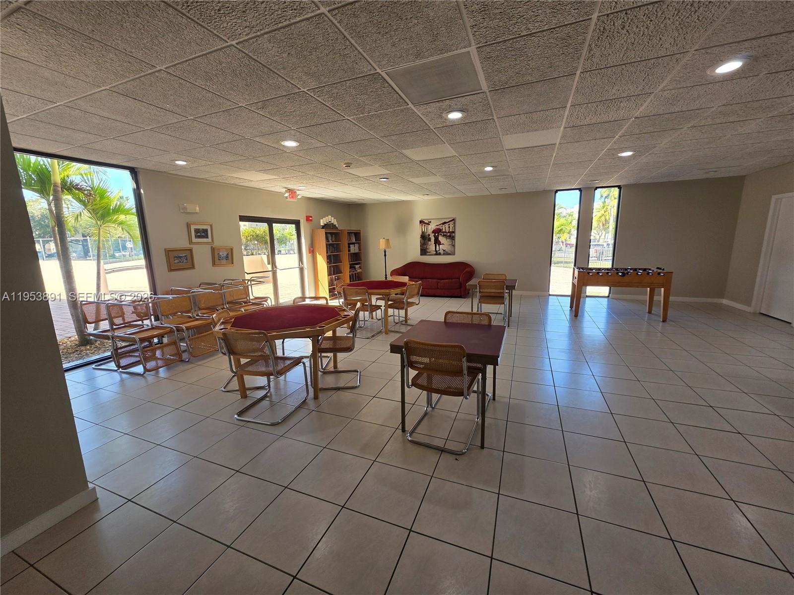 8600 Southwest 133rd Avenue Road, Unit 424 Miami, FL 33183 - Photo 25 of 27 a outdoor space with lots of furniture and a projector