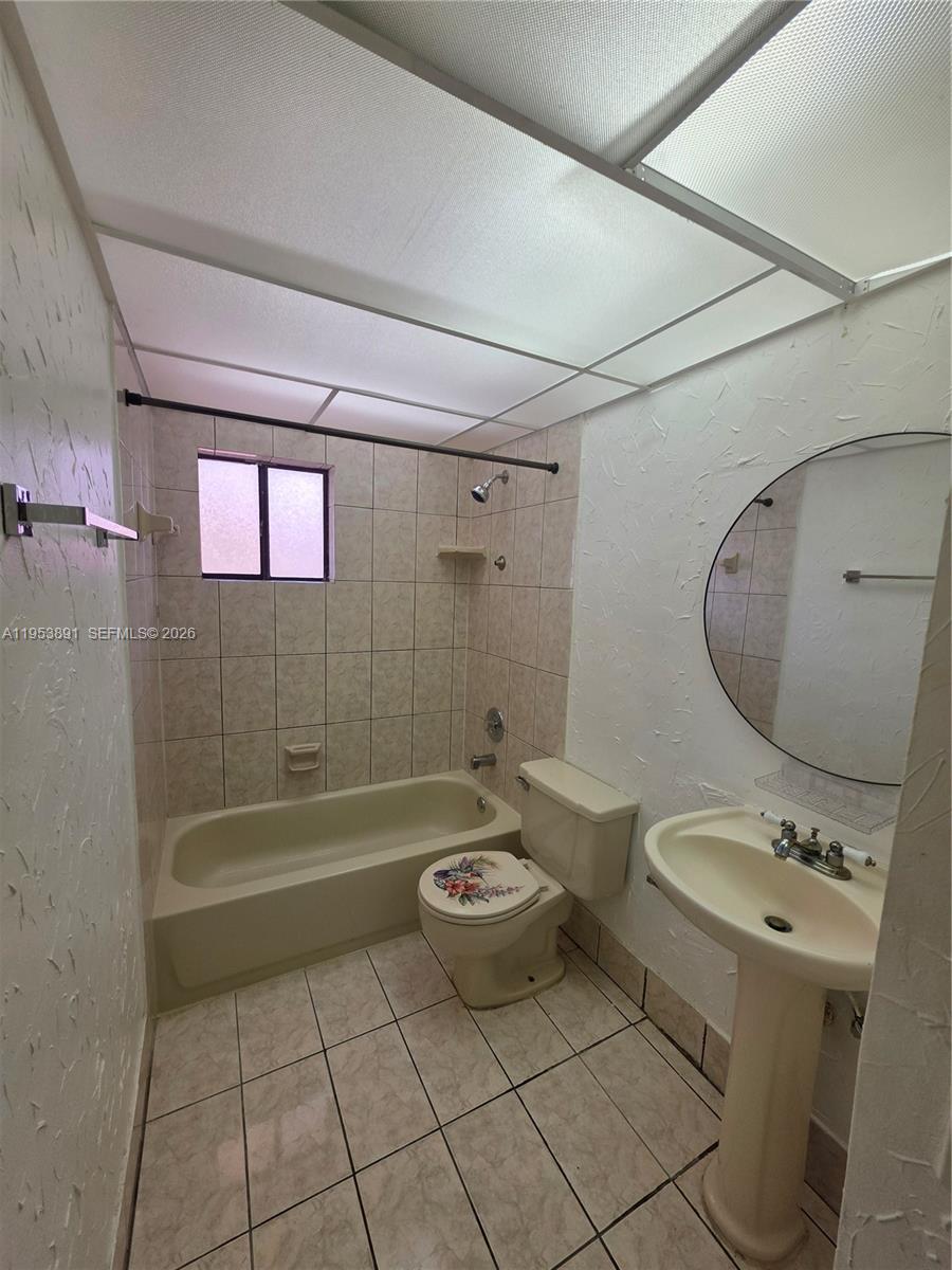 8600 Southwest 133rd Avenue Road, Unit 424 Miami, FL 33183 - Photo 6 of 27 a bathroom with a sink a toilet and shower