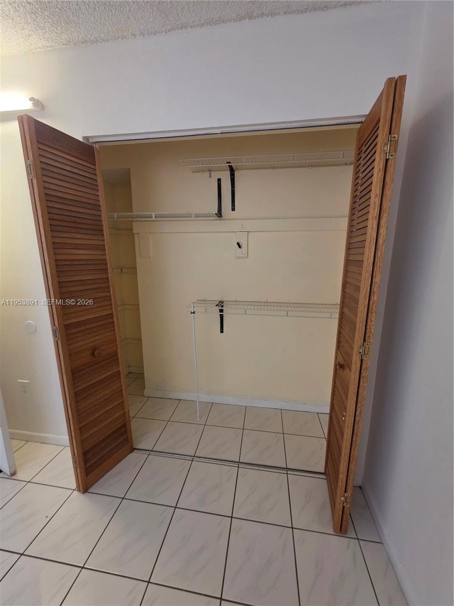 8600 Southwest 133rd Avenue Road, Unit 424 Miami, FL 33183 - Photo 8 of 27 a view of walk in closet with empty racks