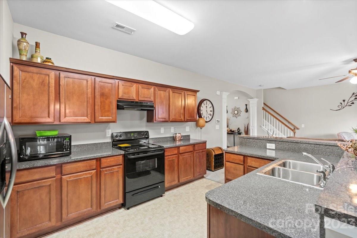 13004 Rothe House Road Charlotte, NC 28273 - Photo 12 of 27 a kitchen with stainless steel appliances granite countertop a sink stove and refrigerator