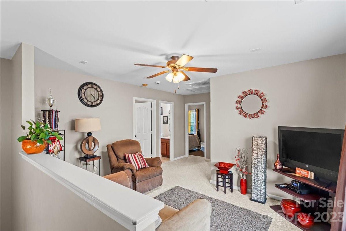 13004 Rothe House Road Charlotte, NC 28273 - Photo 16 of 27 a living room with furniture and a flat screen tv