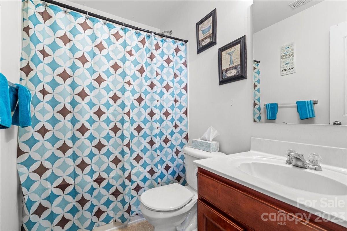13004 Rothe House Road Charlotte, NC 28273 - Photo 19 of 27 a bathroom with a sink and a toilet
