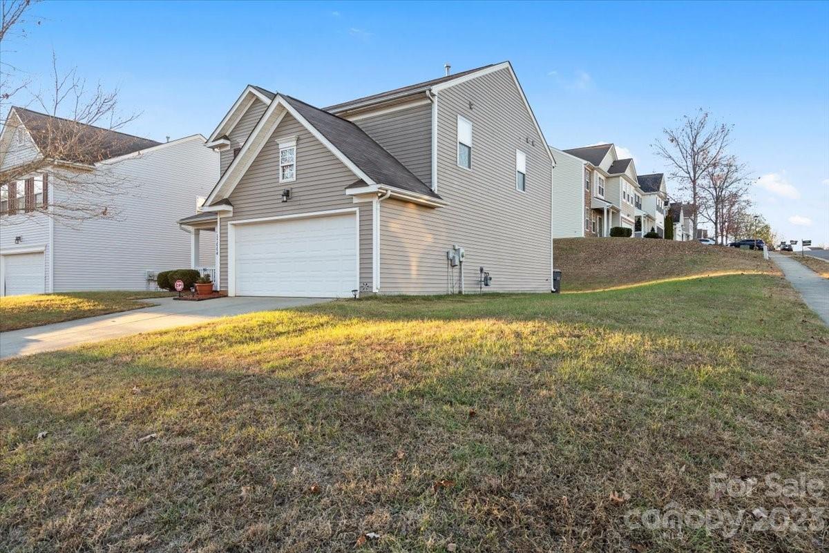 13004 Rothe House Road Charlotte, NC 28273 - Photo 2 of 27 a view of the house with a yard