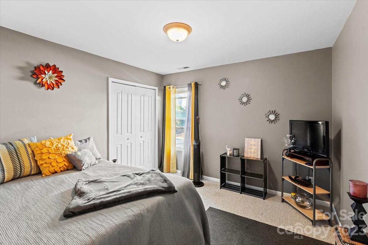 13004 Rothe House Road Charlotte, NC 28273 - Photo 21 of 27 a bedroom with a bed and a flat screen tv