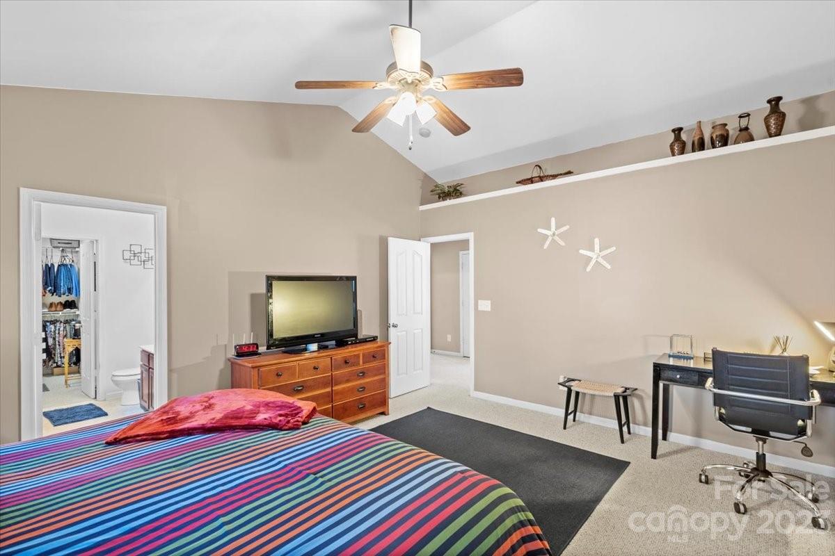 13004 Rothe House Road Charlotte, NC 28273 - Photo 23 of 27 a bedroom with a bed and a flat screen tv