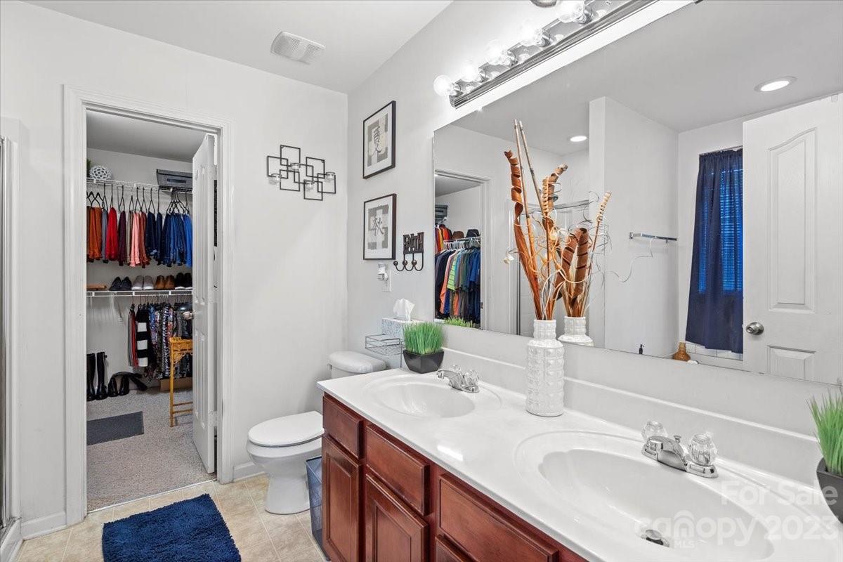 13004 Rothe House Road Charlotte, NC 28273 - Photo 24 of 27 a bathroom with a toilet sink and mirror