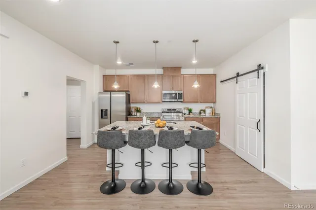 a view of kitchen center island and refrigerator