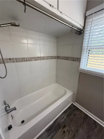 a bathroom with a tub and a window