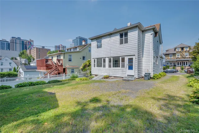 a front view of a house with a yard table and chairs