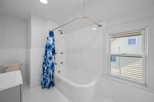 a bathroom with a bathtub and shower