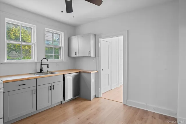 a kitchen with a sink cabinets and window