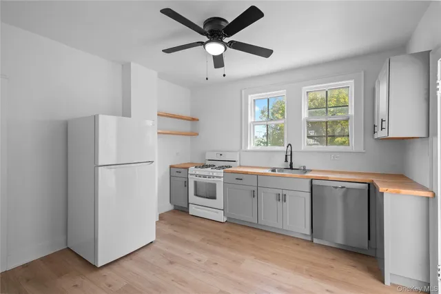 a kitchen with a refrigerator and a sink