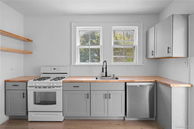 a view of a kitchen with cabinets appliances and a window