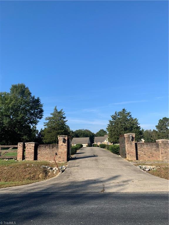 7024 Riverside Road Seagrove, NC 27341 - Photo 5 of 16 Extended driveway with a security gate for entry.