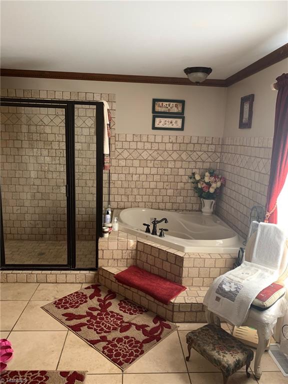 7024 Riverside Road Seagrove, NC 27341 - Photo 7 of 16 Primary bathroom suite features a garden tub & separate shower.