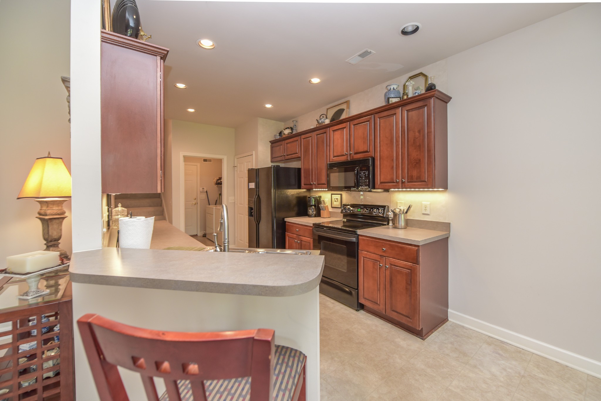 157 Stoners Glen Road Hermitage, TN 37076 - Photo 7 of 24 a kitchen with stainless steel appliances granite countertop a sink a stove a refrigerator a kitchen island with cabinets and wooden floor