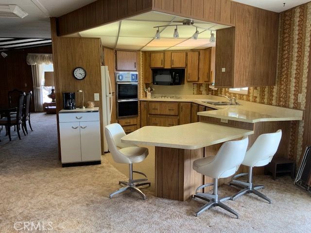 121 Larch Court Bodfish, CA 93205 - Photo 11 of 23 a kitchen with a table chairs and a stove