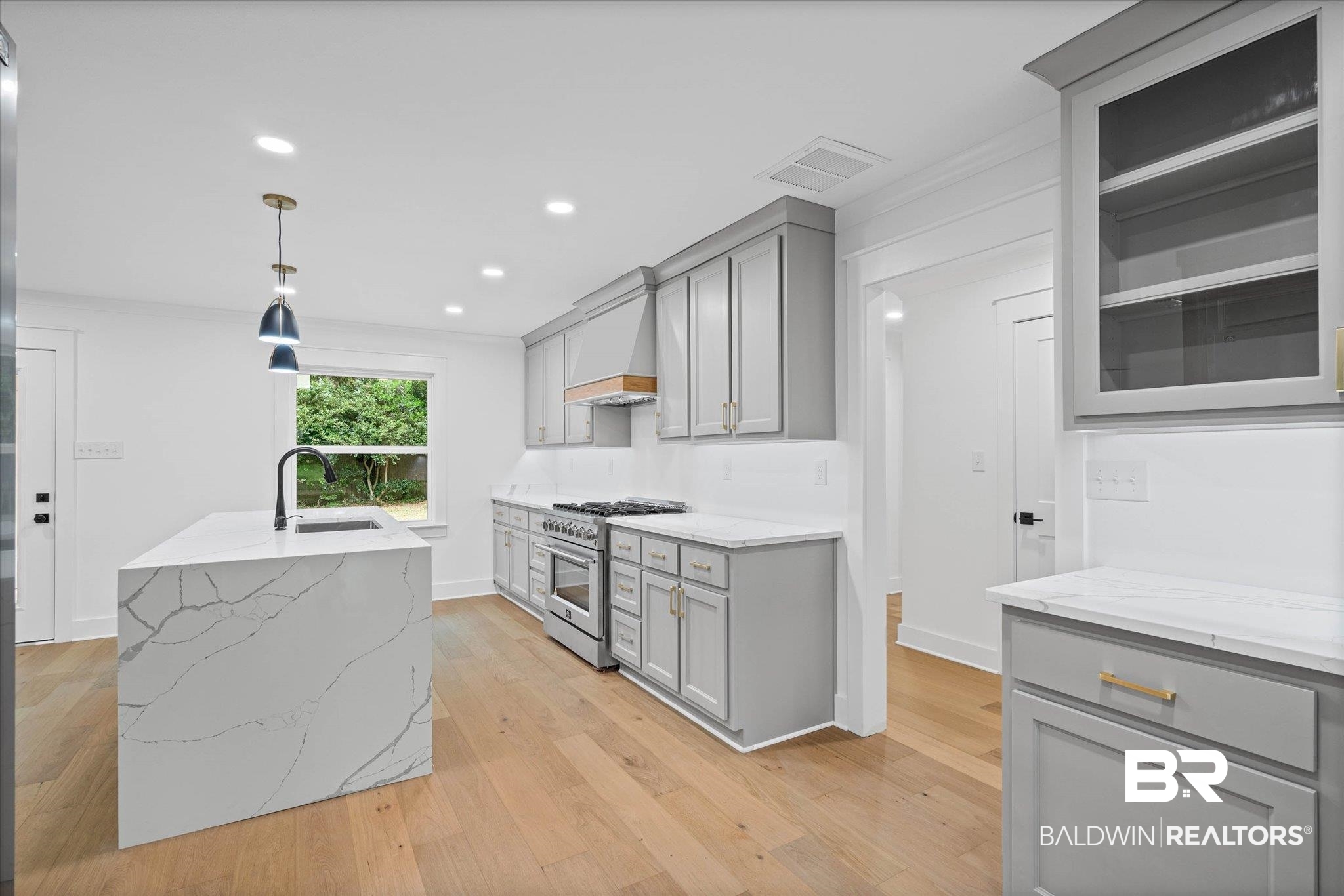 11 Schwaemmle Drive Mobile, AL 36608 - Photo 8 of 32 Kitchen with gray cabinets, high end stainless steel range oven, light stone counters, hanging light fixtures, and light wood-style floors