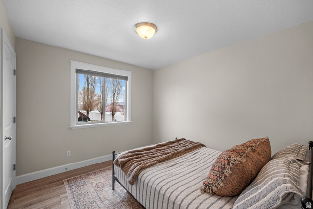 1896 West 800 North Mapleton, UT 84663 - Photo 19 of 55 Bedroom featuring baseboards and light wood-style floors
