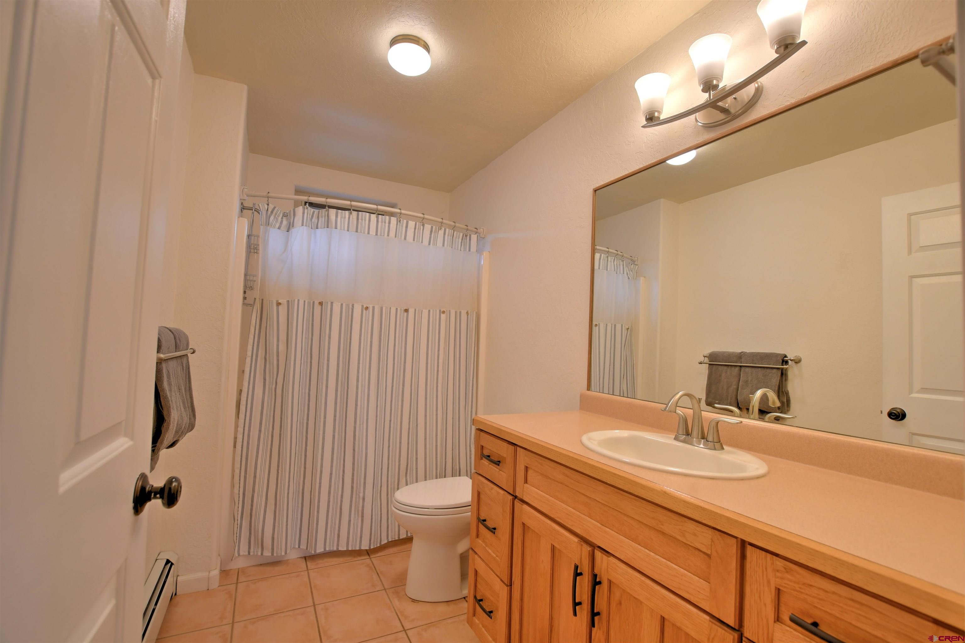 602 Chipeta Drive Ridgway, CO 81432 - Photo 25 of 41 a bathroom with a sink toilet double vanity and shower