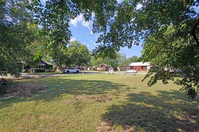 a view of yard with swimming pool and trees
