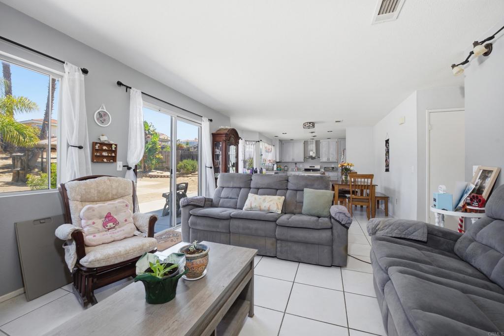 2077 Westwood Road Vista, CA 92083 - Photo 12 of 37 a living room with furniture and a large window