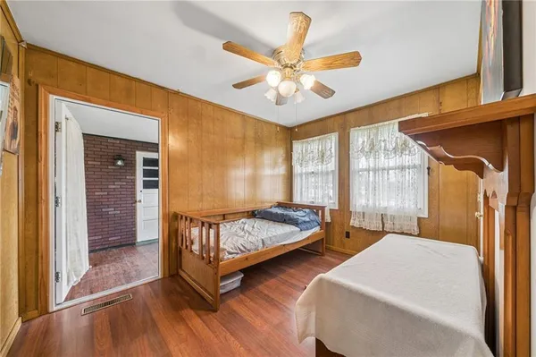 a bedroom with two beds and window